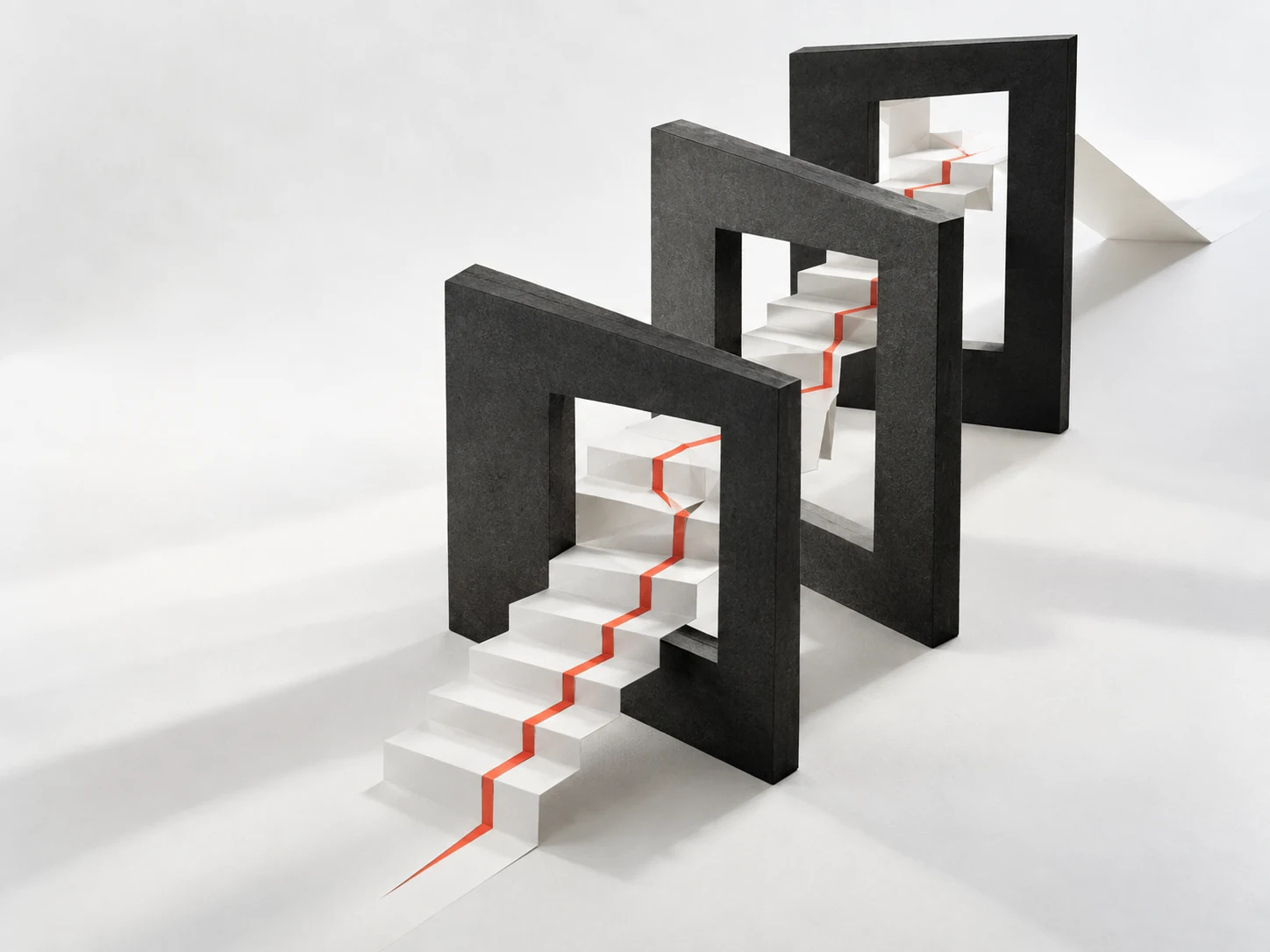 A white folded staircase marked by a red line passes through three offset black frames